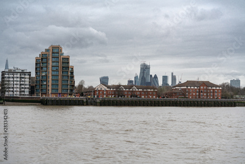 The Towers Of City of London oversee River Side Apartments  Flats and houses along the banks of The River Thames