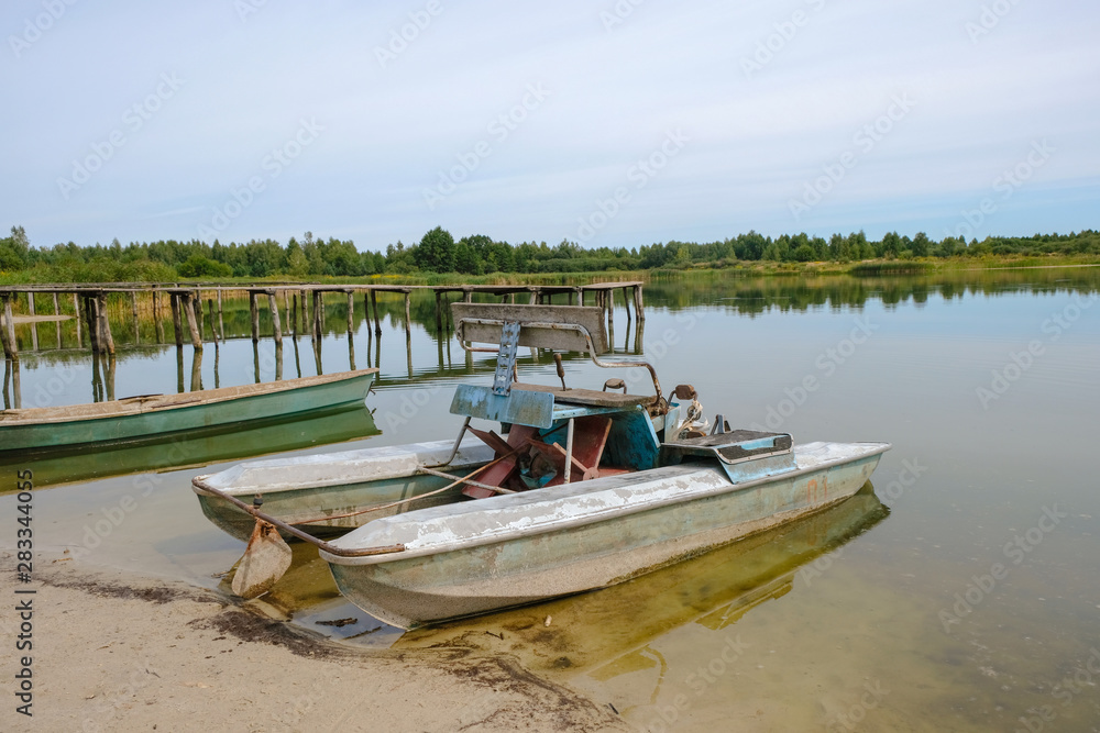 Small lake in Ukraine in drought. Water transport on sandy shore. Small lake in Ukraine in drought. Water transport on sandy shore.