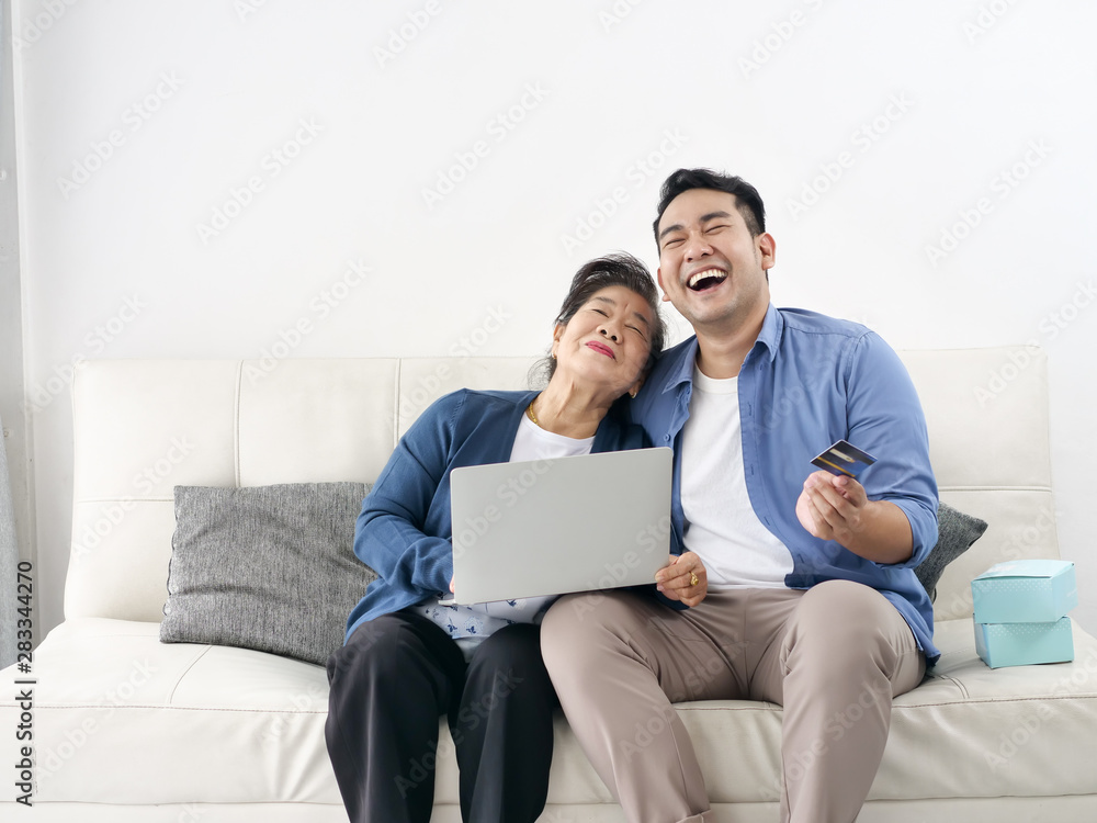 Asian man teaching his mother for shopping online, modern lifestyle concept. Asian man teaching his mother for shopping online, modern lifestyle concept.