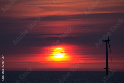 windturbine at the sea in the sunset