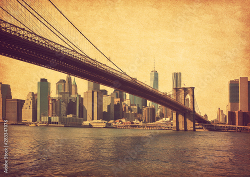 Fototapeta Naklejka Na Ścianę i Meble -  Brooklyn Bridge and Lower Manhattan  in New York City, United States. Photo in retro style. Added paper texture.