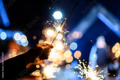 Burning sparkler, Happy New Year. Bengal fire sparkles against the background