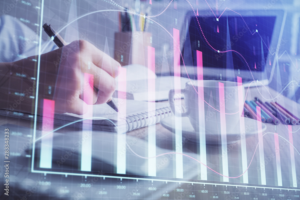 Financial chart drawn over hands taking notes background. Concept of research. Double exposure Financial chart drawn over hands taking notes background. Concept of research. Double exposure