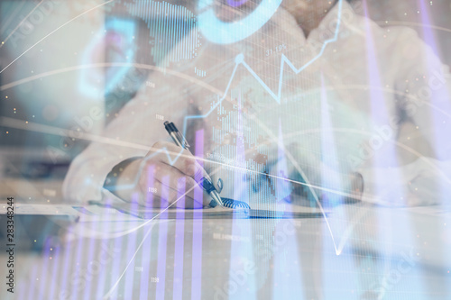 Financial chart drawn over hands taking notes background. Concept of research. Multi exposure