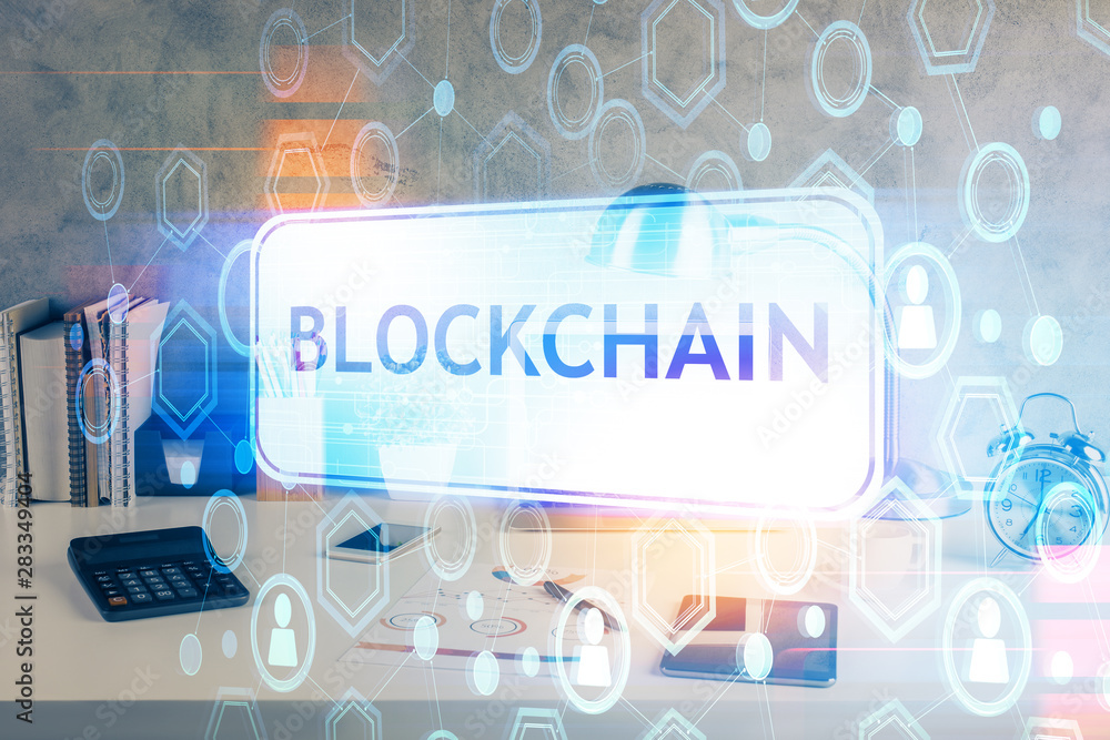 Double exposure of blockchain and crypto economy theme hologram and table with computer background. Concept of bitcoin cryptocurrency.