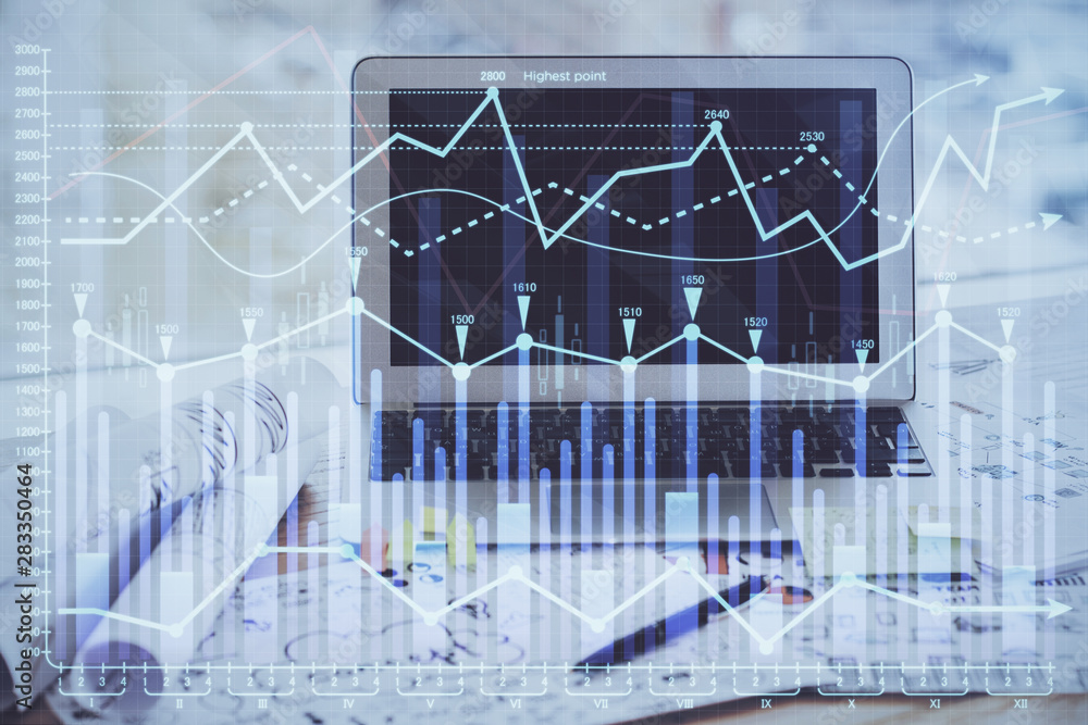 Financial market graph hologram and personal computer on background. Double exposure. Concept of forex.