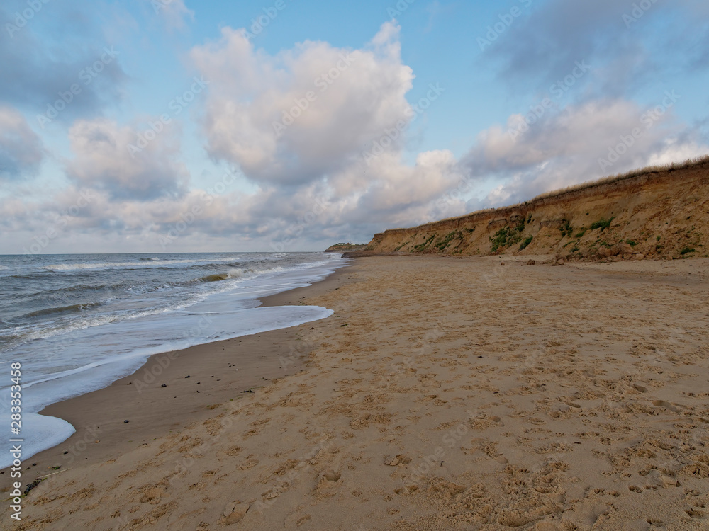 The incoming North Sea washes up Happisburgh beach towards the fragile soft sandy cliffs. The incoming North Sea washes up Happisburgh beach towards the fragile soft sandy cliffs.