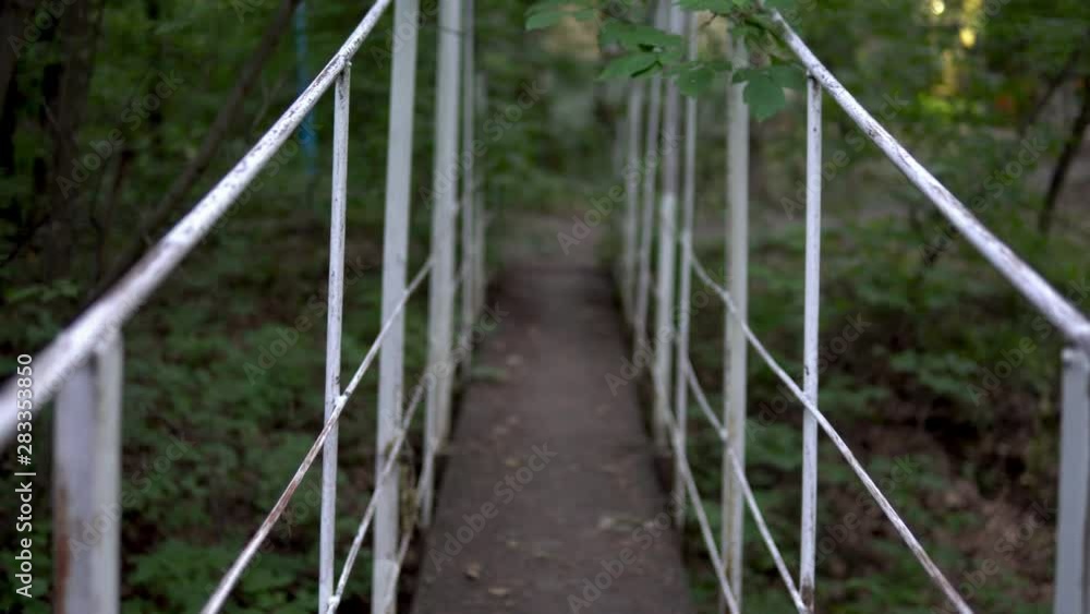 Passage over the bridge in the middle of the forest. First-person view Passage over the bridge in the middle of the forest. First-person view