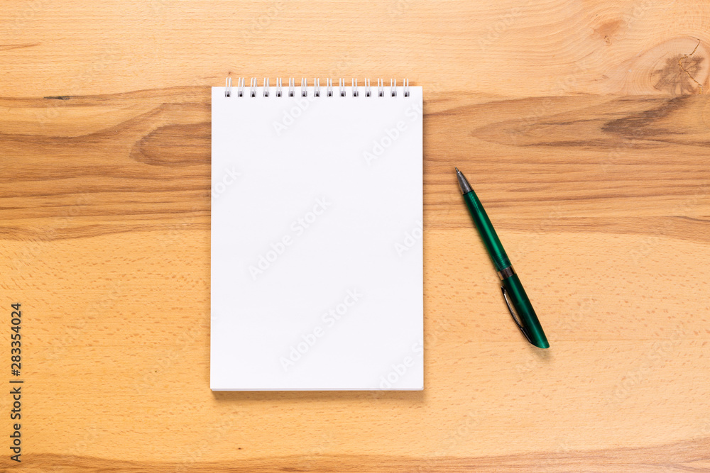 school notepad and pen on the wooden desk. spiral notepad on a tableschool notepad and pen on the wooden desk. spiral notepad on a table school notepad and pen on the wooden desk. spiral notepad on a tableschool notepad and pen on the wooden desk. spiral notepad on a table