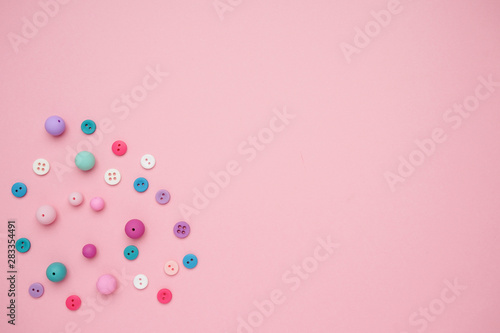 Collection of Colourful Sewing Buttons on Pink Background with Copy Space © KatrinaEra