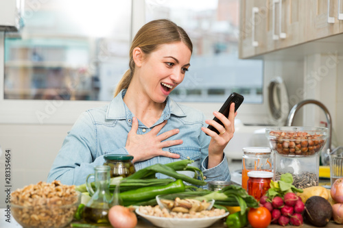 Enthusiastic woman with smartphone