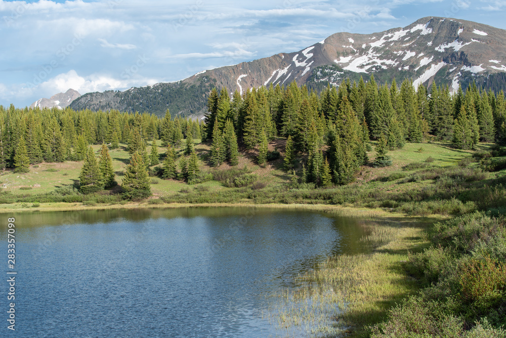 Landscape of little molas lake, forest, and snow-dappled San Juan Mountains