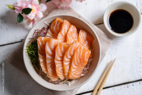 Salmon sashimi with soy sauce, raw fish in traditional Japanese style