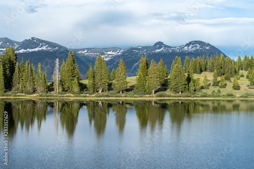 Fototapeta Naklejka Na Ścianę i Meble -  Colorado landscape of snow capped mountains and trees reflected in Little Molas Lake in the San Juan Mountains