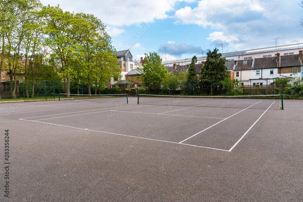 Empty tennis courts in a park on a spring day
