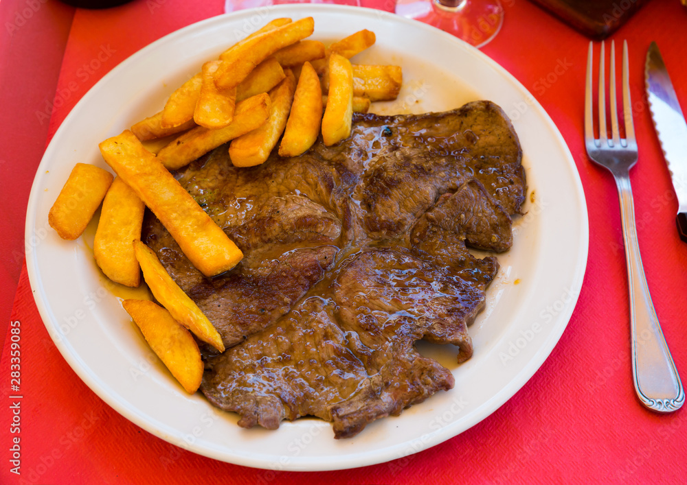 Tasty veal fillet with fried potatoes