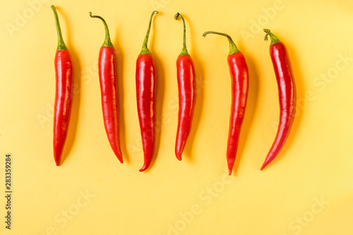 Red hot chili peppers pattern on yellow background,