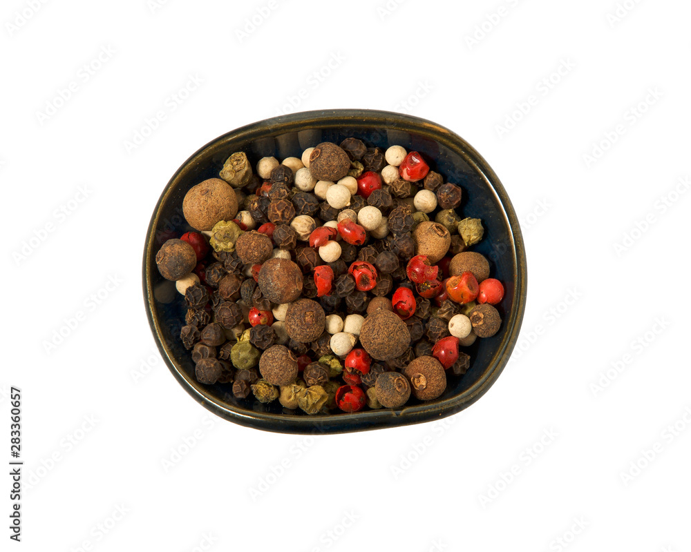 A mixture of peppers in a bowl on isolate. View from above. Seasoning with peas mixed pepper isolated on a white background. Close-up. A mixture of peppers in a bowl on isolate. View from above. Seasoning with peas mixed pepper isolated on a white background. Close-up.