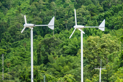 Wind turbine against clean energy, create energy in the forest.