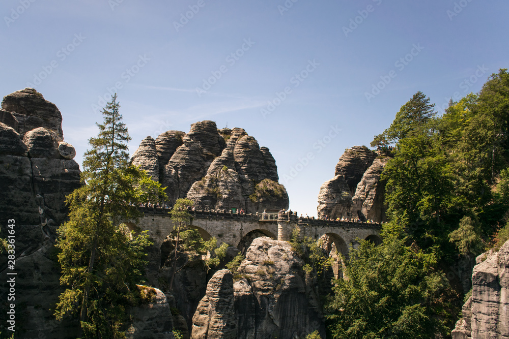 rock formation czech republic europe sunny day summer blue sky green forest, people