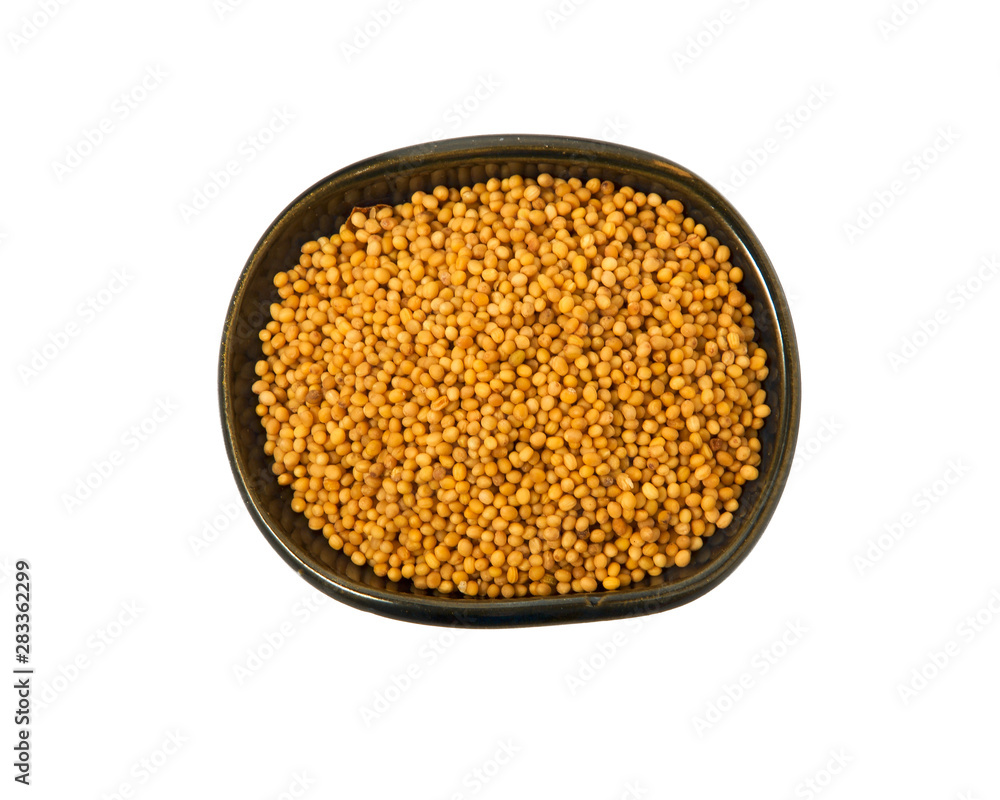 Mustard seeds in a bowl isolated on a white background. Seasoning on isolate. View from above.