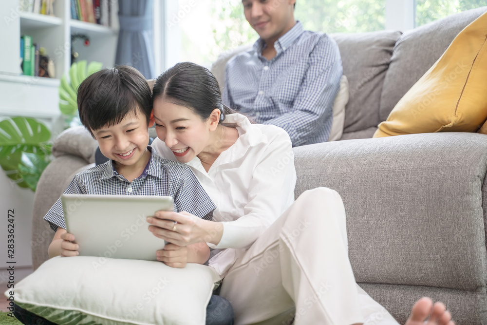 happy asian family spending time together on sofa in living room. family and home concept happy asian family spending time together on sofa in living room. family and home concept