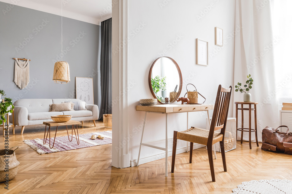 Modern and design home interior of open space with wooden desk, coffee table, sofa, chair, plants, mirror, macrame and elegant accessories. Stylish and minimalistic home decor. Template. Bright rooms. Modern and design home interior of open space with wooden desk, coffee table, sofa, chair, plants, mirror, macrame and elegant accessories. Stylish and minimalistic home decor. Template. Bright rooms.