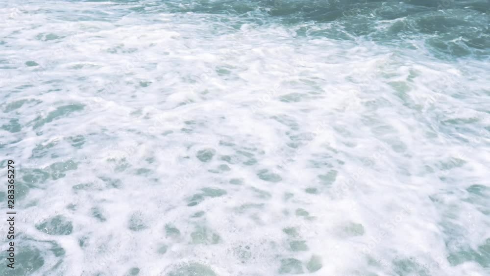 Beautiful sea with blue water. Sea pebbles and waves. clear water near shore with pebbles at bottom. Sea waves crashing on shore and flowing above seashore pebble. Travel and vacation season. 4k shot Beautiful sea with blue water. Sea pebbles and waves. clear water near shore with pebbles at bottom. Sea waves crashing on shore and flowing above seashore pebble. Travel and vacation season. 4k shot