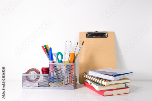 Back to school concept. Pencil, pen and supplies in holder on white background