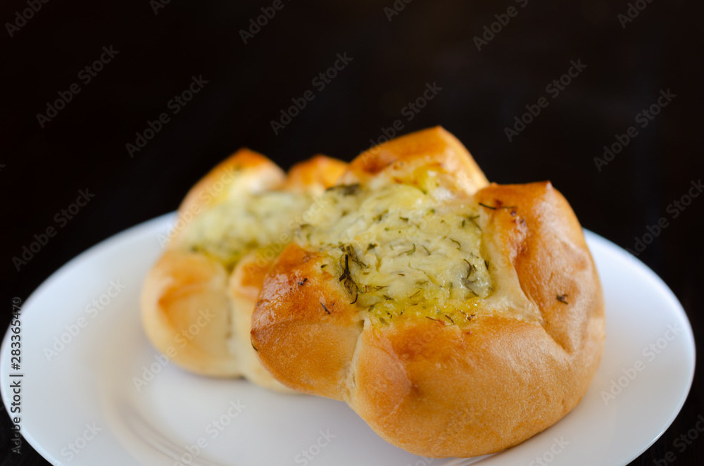 Homemade buns in white plate on wooden background Homemade buns in white plate on wooden background