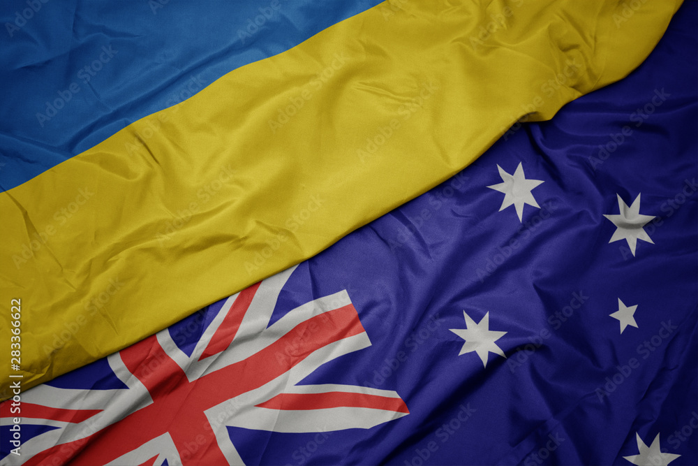 waving colorful flag of australia and national flag of ukraine. waving colorful flag of australia and national flag of ukraine.