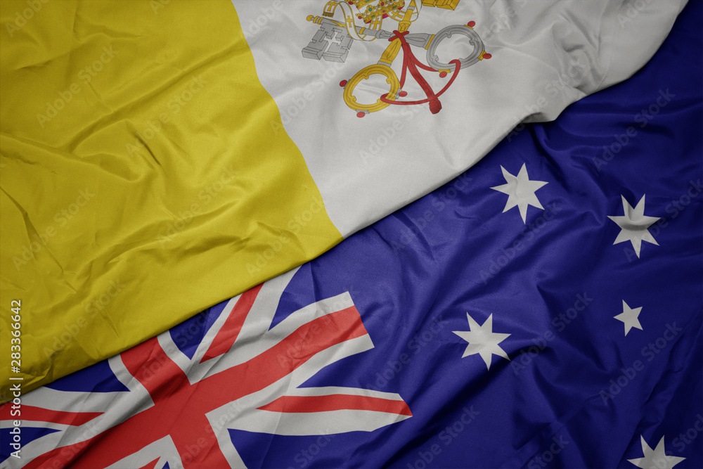 waving colorful flag of australia and national flag of vatican city. waving colorful flag of australia and national flag of vatican city.