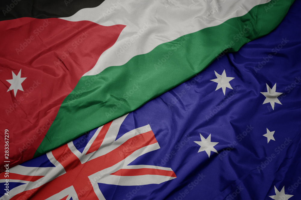 waving colorful flag of australia and national flag of jordan. waving colorful flag of australia and national flag of jordan.