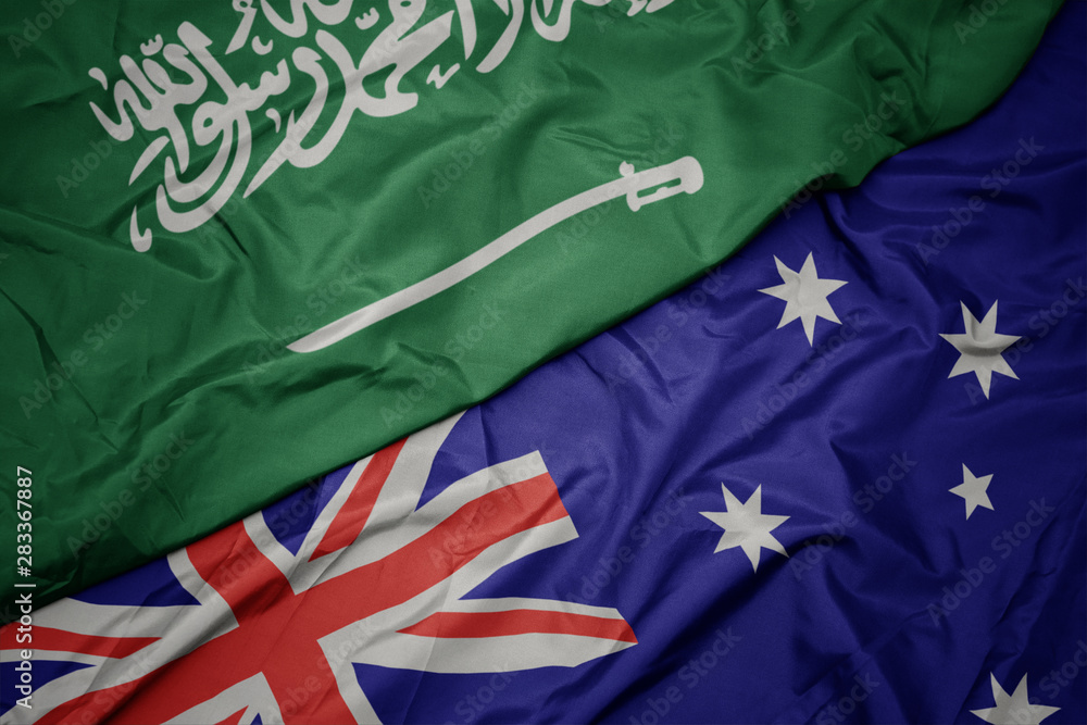 waving colorful flag of australia and national flag of saudi arabia. waving colorful flag of australia and national flag of saudi arabia.