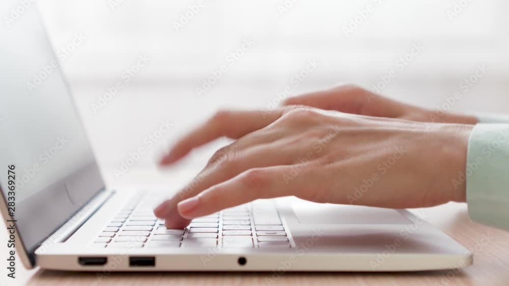 Woman freelancer working on laptop at home-office. Close up of female hands typing on keyboard. Businesswoman writing business letter at work. Pedestal shot Woman freelancer working on laptop at home-office. Close up of female hands typing on keyboard. Businesswoman writing business letter at work. Pedestal shot