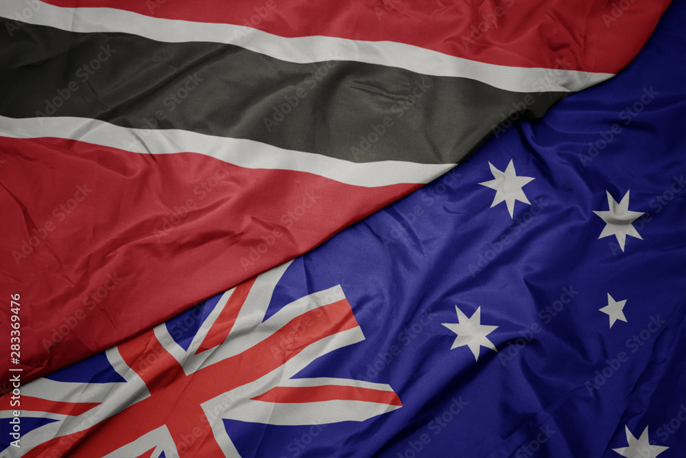 waving colorful flag of australia and national flag of trinidad and tobago. waving colorful flag of australia and national flag of trinidad and tobago.