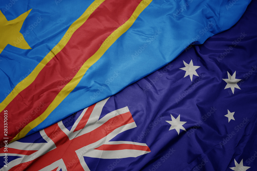 waving colorful flag of australia and national flag of democratic republic of the congo. waving colorful flag of australia and national flag of democratic republic of the congo.