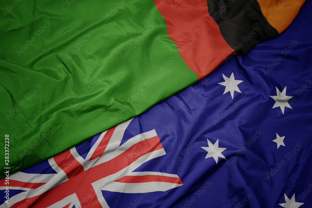 waving colorful flag of australia and national flag of zambia. waving colorful flag of australia and national flag of zambia.