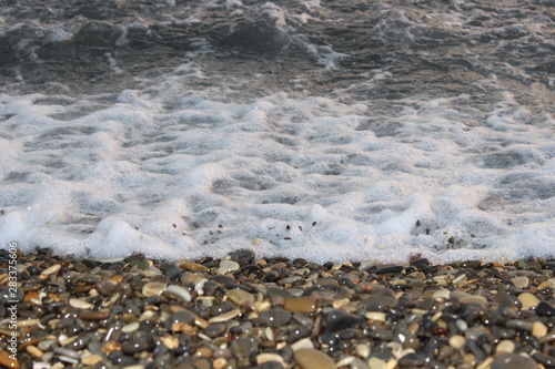 Landscape of waves on the beach and dry stones