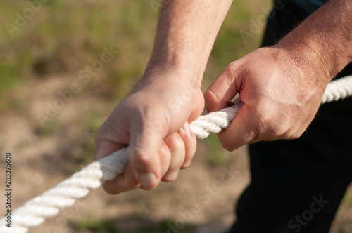 the man pulls the rope