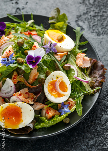 Smoked salmon and jammy soft-boiled free range egg and capers salad with edible borage and pansy flowers