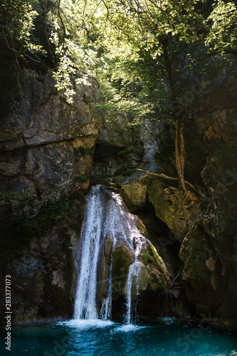 Beautiful hidden waterfall inside the forest in Pyrenees