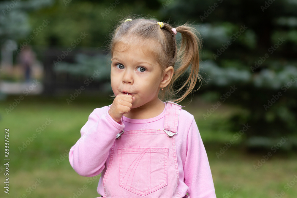 Beautiful child with lollipop in the summer park Beautiful child with lollipop in the summer park