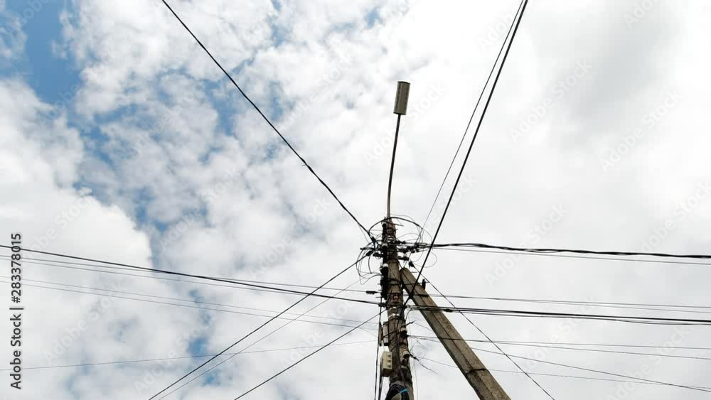 Overhead Electricity Lines And Power Wires On Blue Sky Background Handheld Motion . Overhead Electricity Lines And Power Wires On Blue Sky Background Handheld Motion .