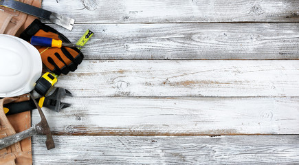 Labor Day concept with worker tools over distressed white wooden background