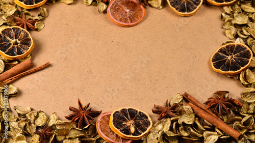 Autumn background with golden leaves, dried fruts, cinnamon and anis. Space for text or design.