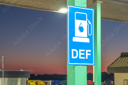 Diesel exhaust fluid or DEF sign posted in a truck stop, next to fuel pump photo