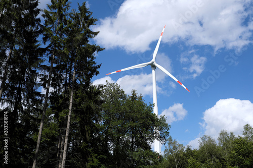 Wind turbines and trees in a forest - Stockphoto