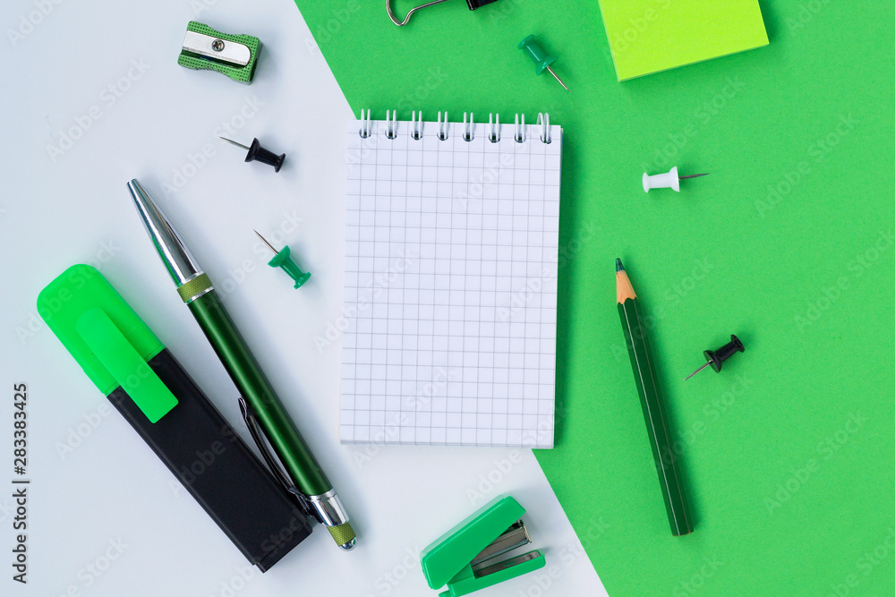 notebook and pencil isolated on white and green background with copy space notebook and pencil isolated on white and green background with copy space