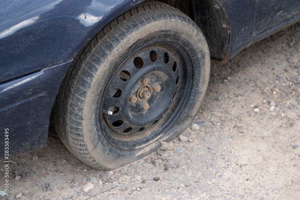 Car with deflated wheel on street. Old car with deflated wheel parked on street Car with deflated wheel on street. Old car with deflated wheel parked on street